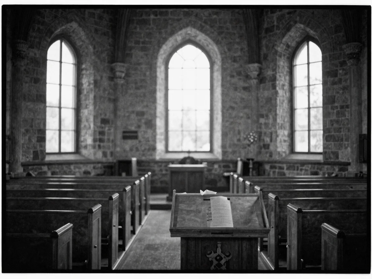 Black-and-white editorial documentary photograph of a stone churc